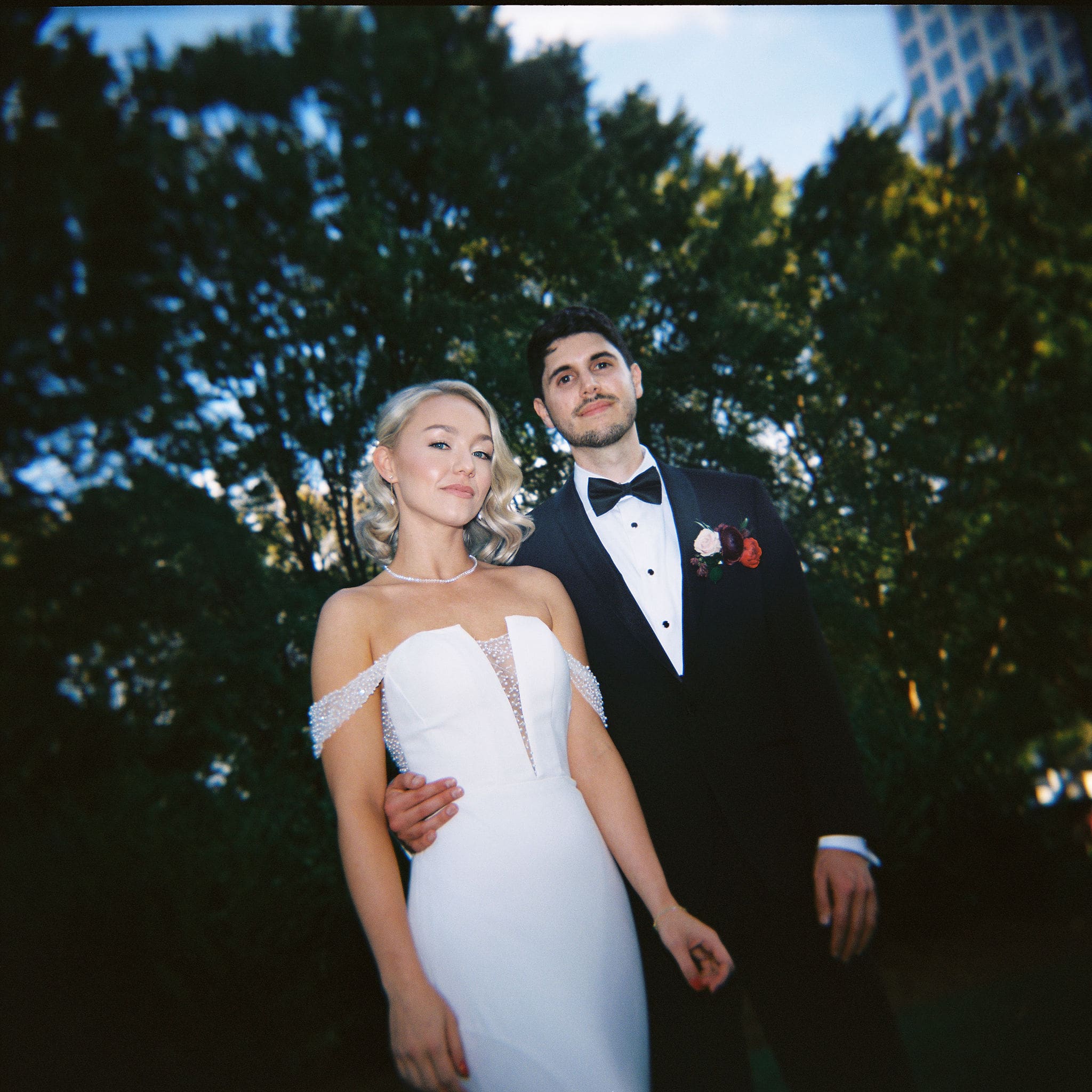 Bride and groom portrait in an urban park at golden hour