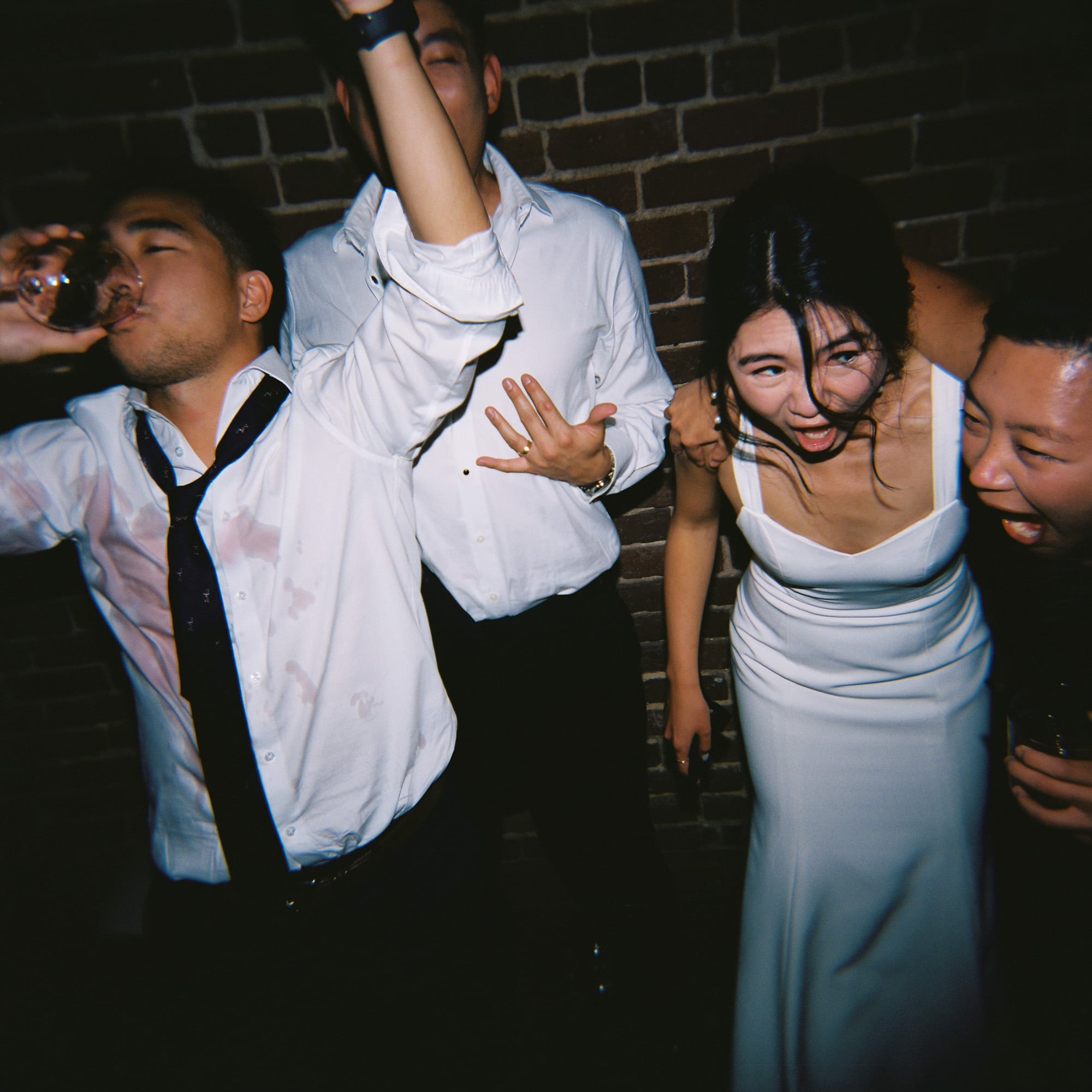 Wedding guests celebrating energetically on the dance floor